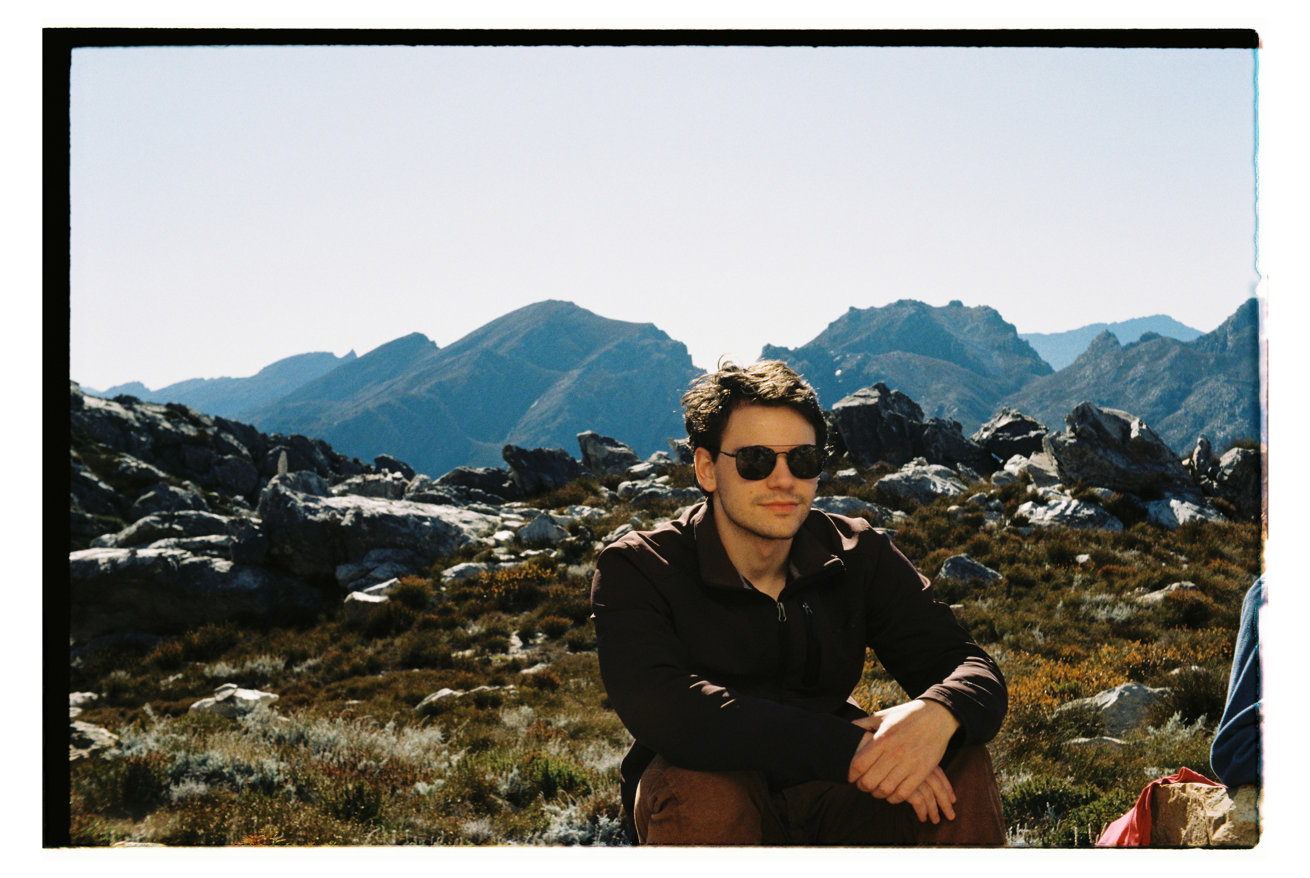 Man wearing sunglasses on a mountain.