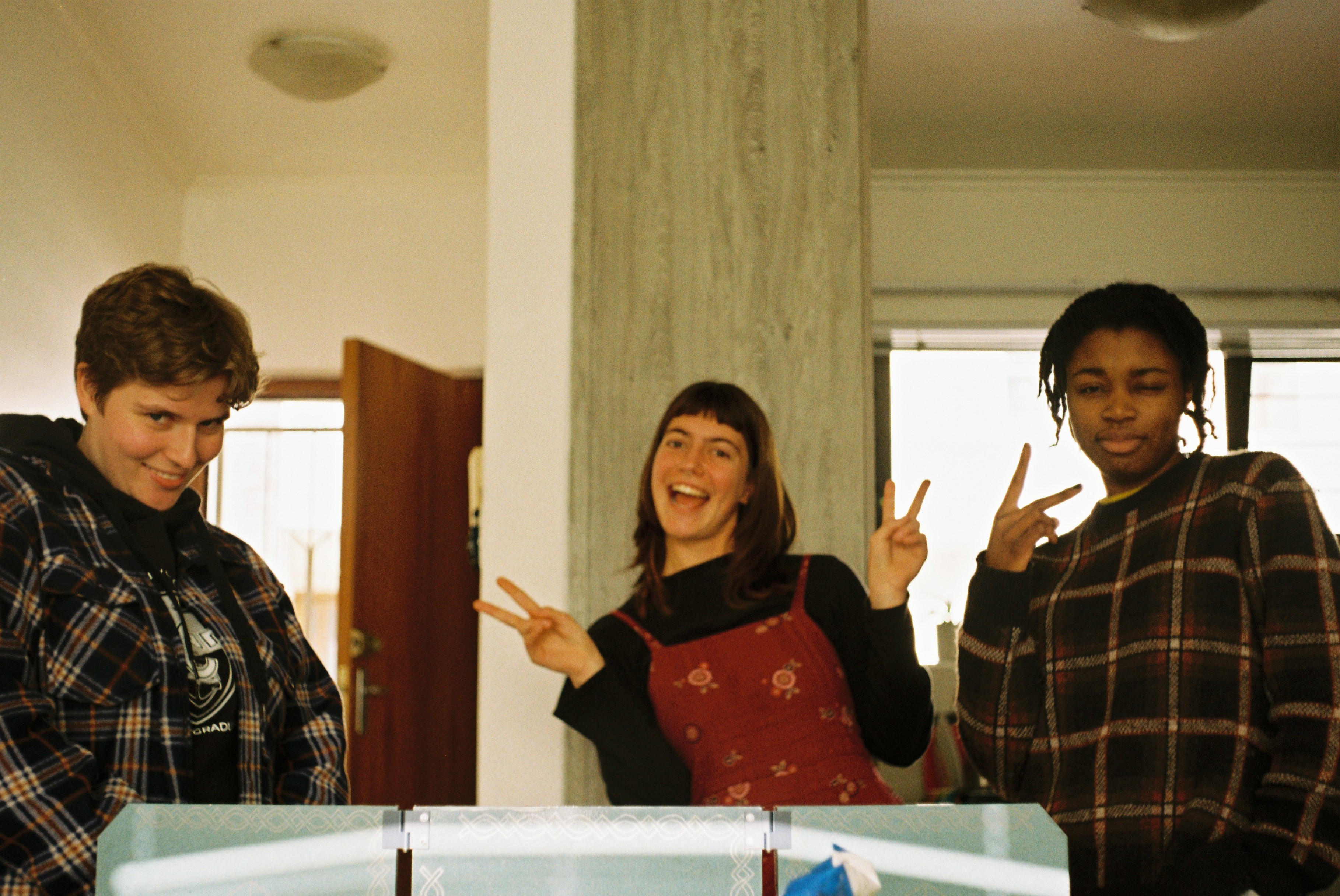 Three woman pose for the camera.