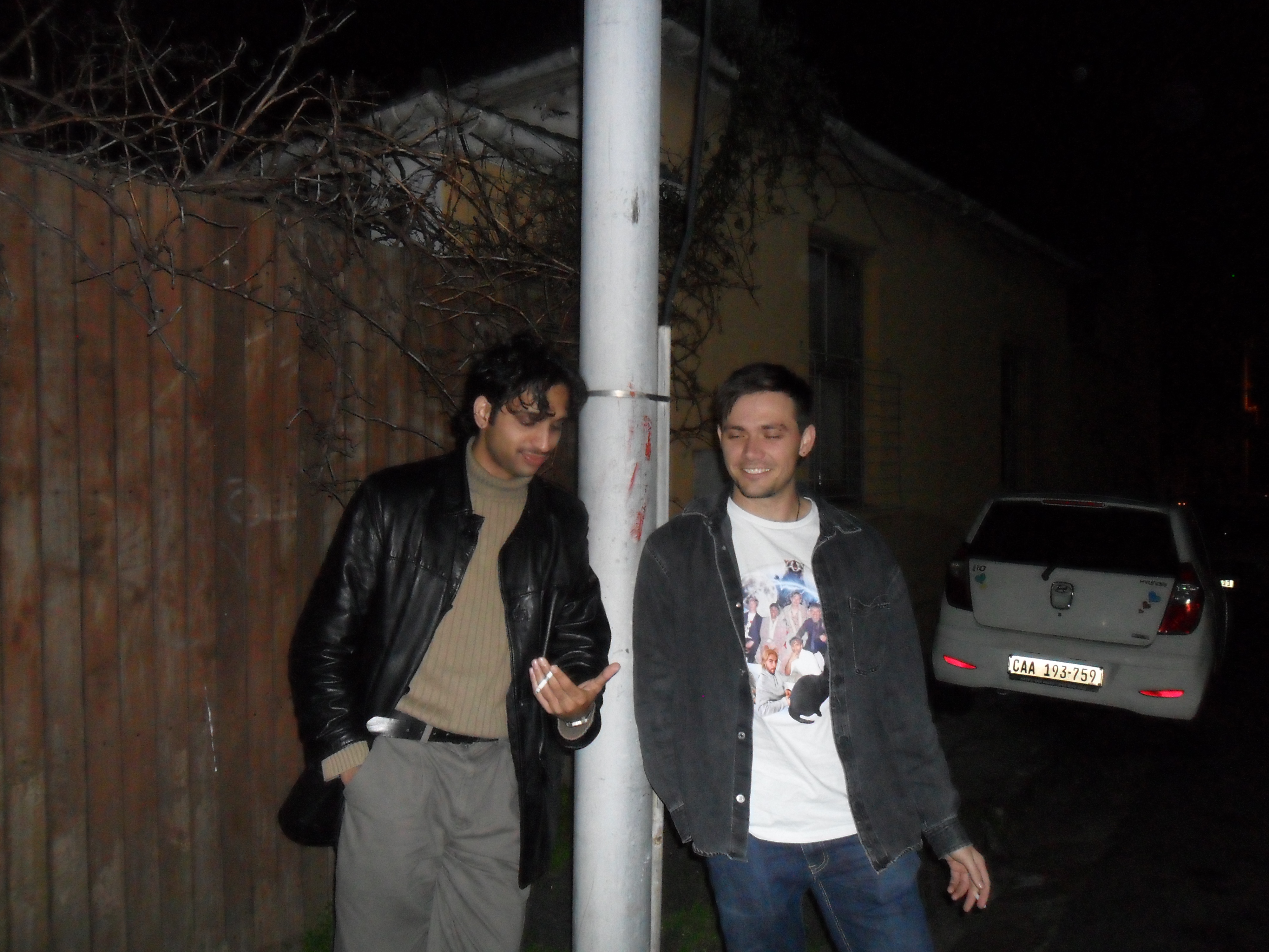 Two men share a cigarette.