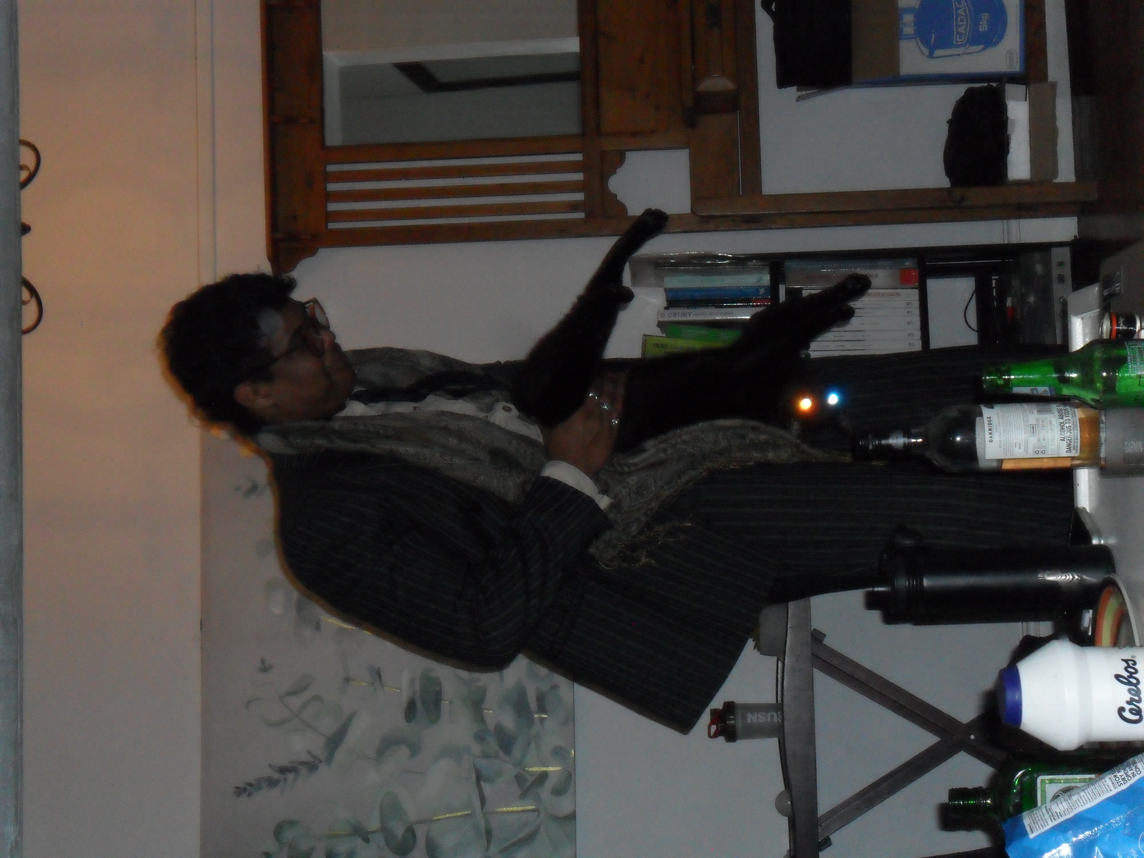 Man plays with black cat.